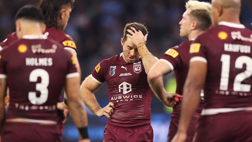 Ben Hunt puts his hand in his hair sadly. Other Queensland Maroons are in the foreground during State of Origin II.