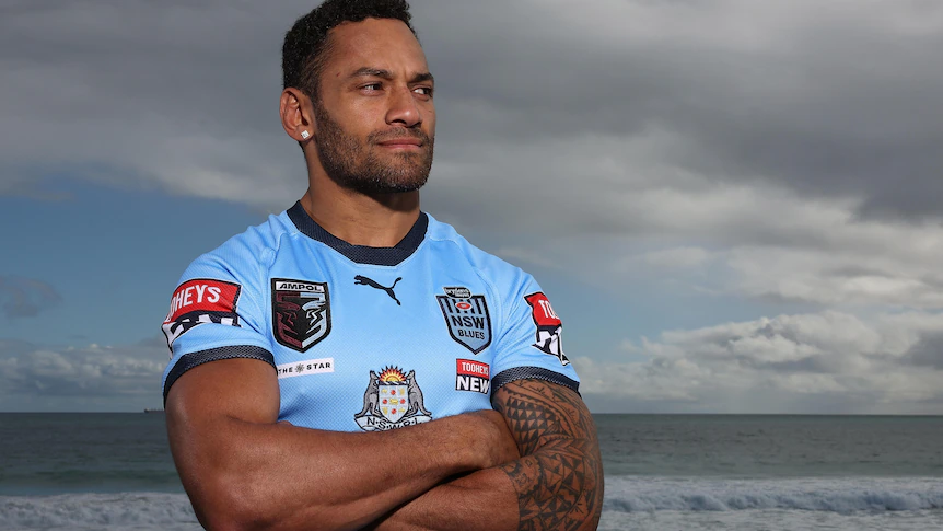 Apisai Koroisau poses for a photo at the beach in his Blues kit