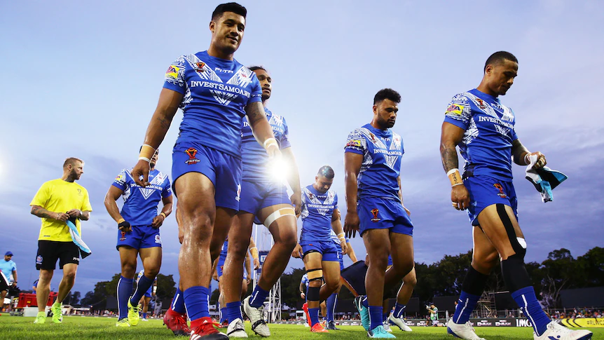 A group of rugby league players leave the field after losing a match