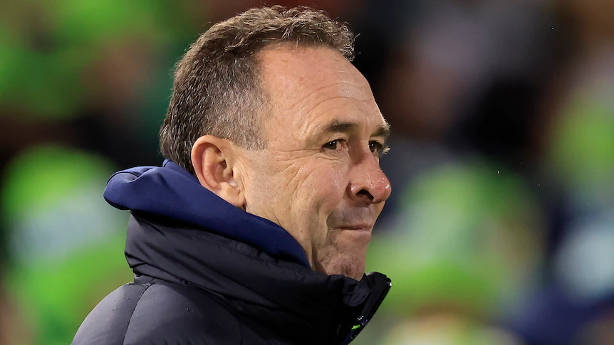 The Canberra Raiders NRL coach looks to his right during a match.