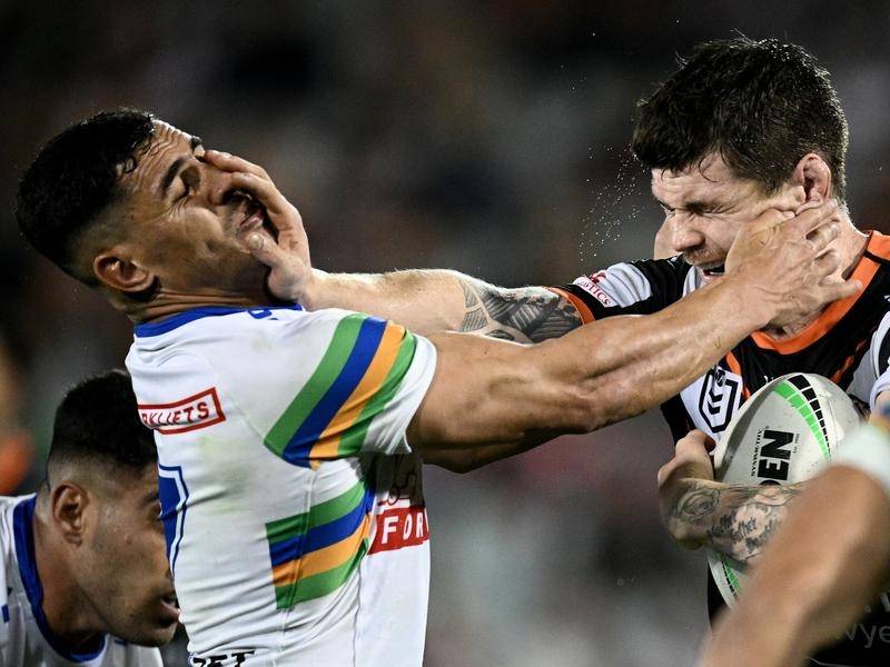 Raider Jamal Fogarty (left) felt sorry for the Wests Tigers after his game winning penalty goal. (Dan Himbrechts/AAP PHOTOS)