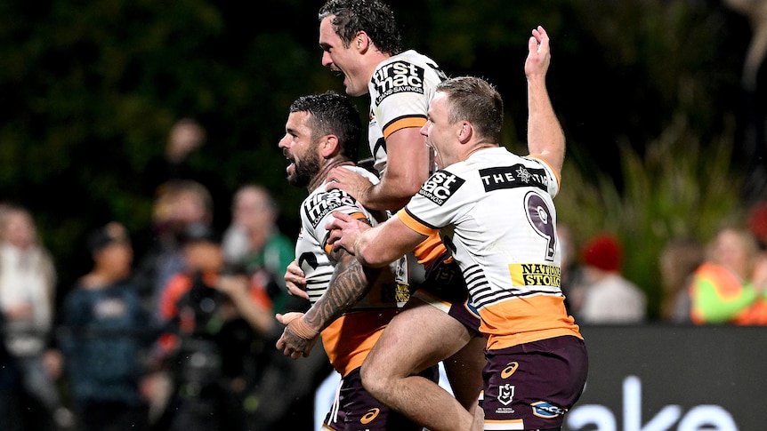 A group of players celebrate a win