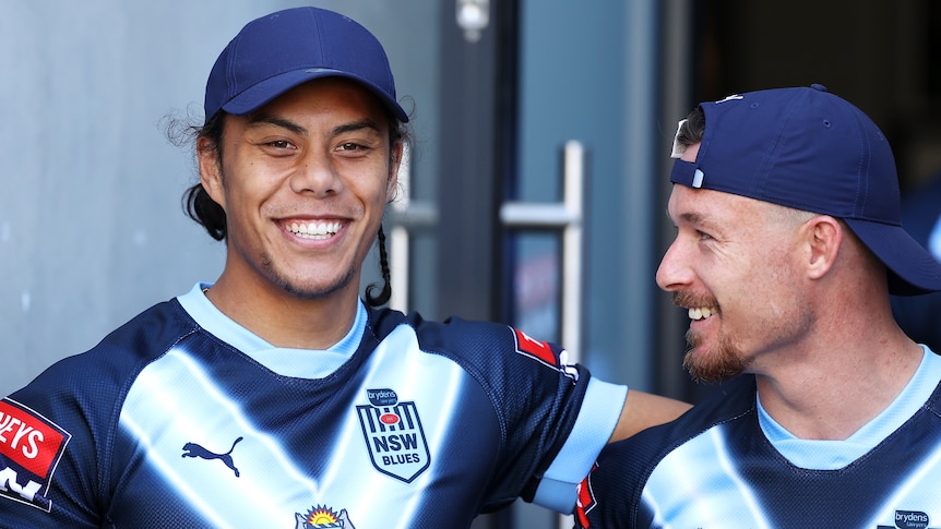 Two men wearing blues gear.