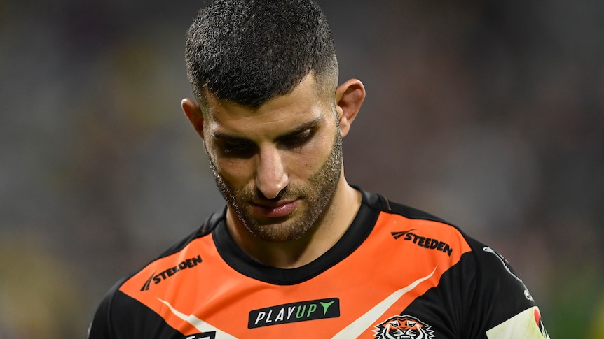 A man looks sad after losing a rugby league match