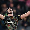 Nathan Cleary throws his head back and arms in the air during an NRL game.