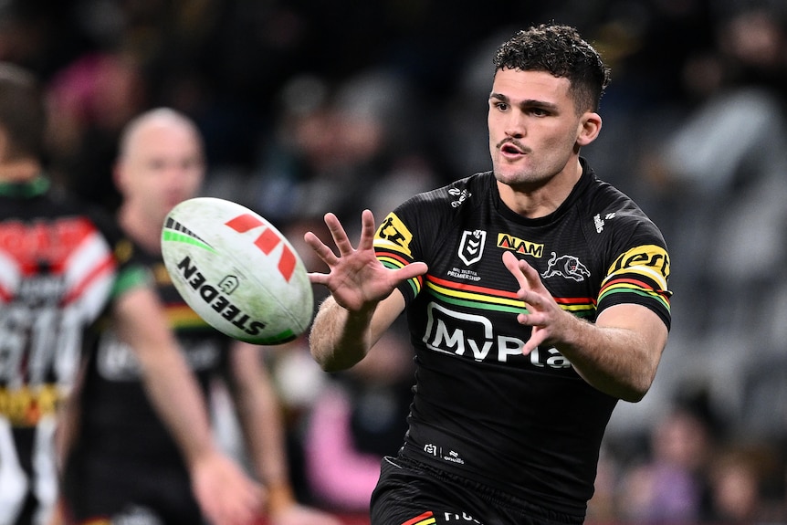 Nathan Cleary in a warm up,. with his arms stretched in front of him, preparing to catch a ball