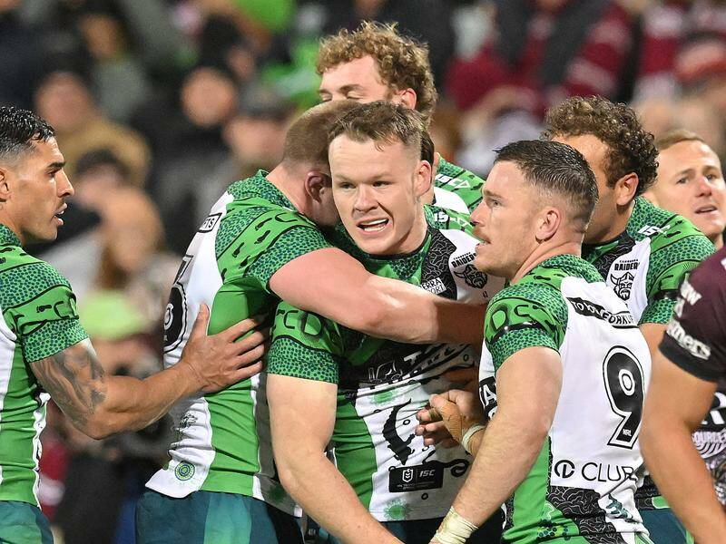 Young Canberra star Ethan Strange (c) scored three tries as the Raiders defeated Manly. Photo: Mick Tsikas/AAP PHOTOS