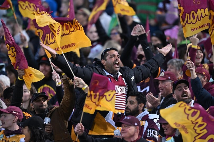 Brisbane Broncos fans at Canberra Stadium cheering and waving flags