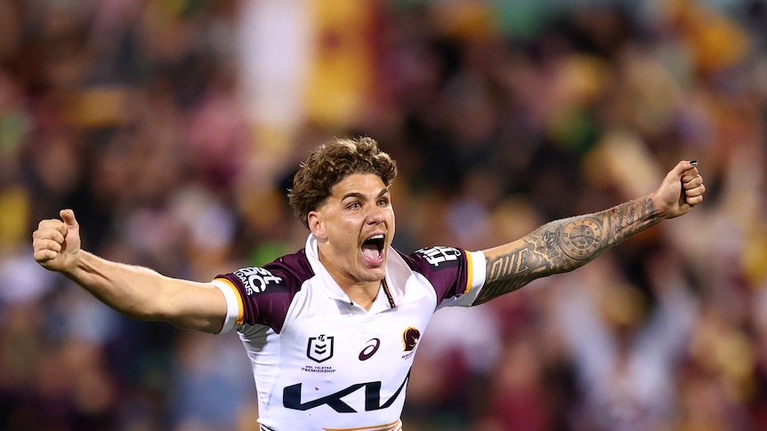 A man celebrates after winning a rugby league match