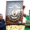 Pictured left, Raiders coach Ricky Stuart holding the NRL minor premiers shield.