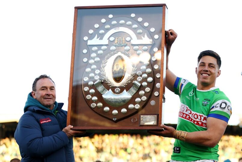 Pictured left, Raiders coach Ricky Stuart holding the NRL minor premiers shield.