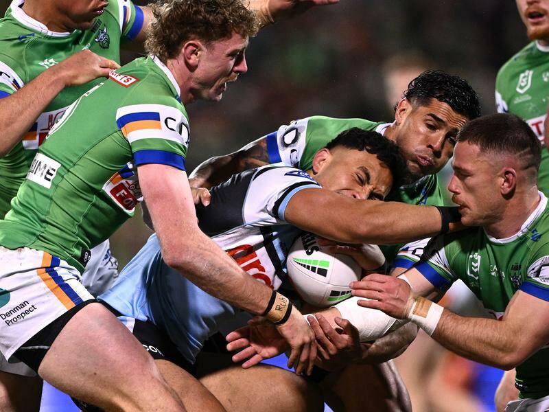 Cronulla's Iro loves a challenge as evidenced by taking on an army of Raiders here. Photo: Dan Himbrechts/AAP PHOTOS