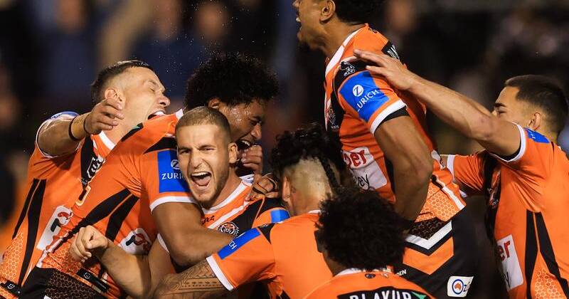 Adam Douehi (centre) has been embraced by his teammates following a tumultous time for the Tigers. Photo: Mark Evans/AAP PHOTOS